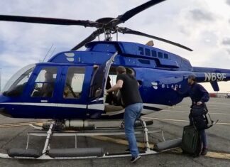 a group of people getting off a helicopter