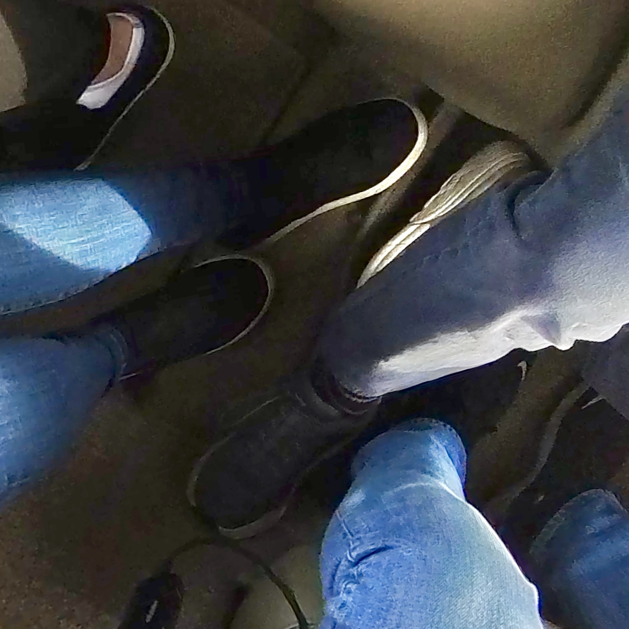a group of people's legs in a car