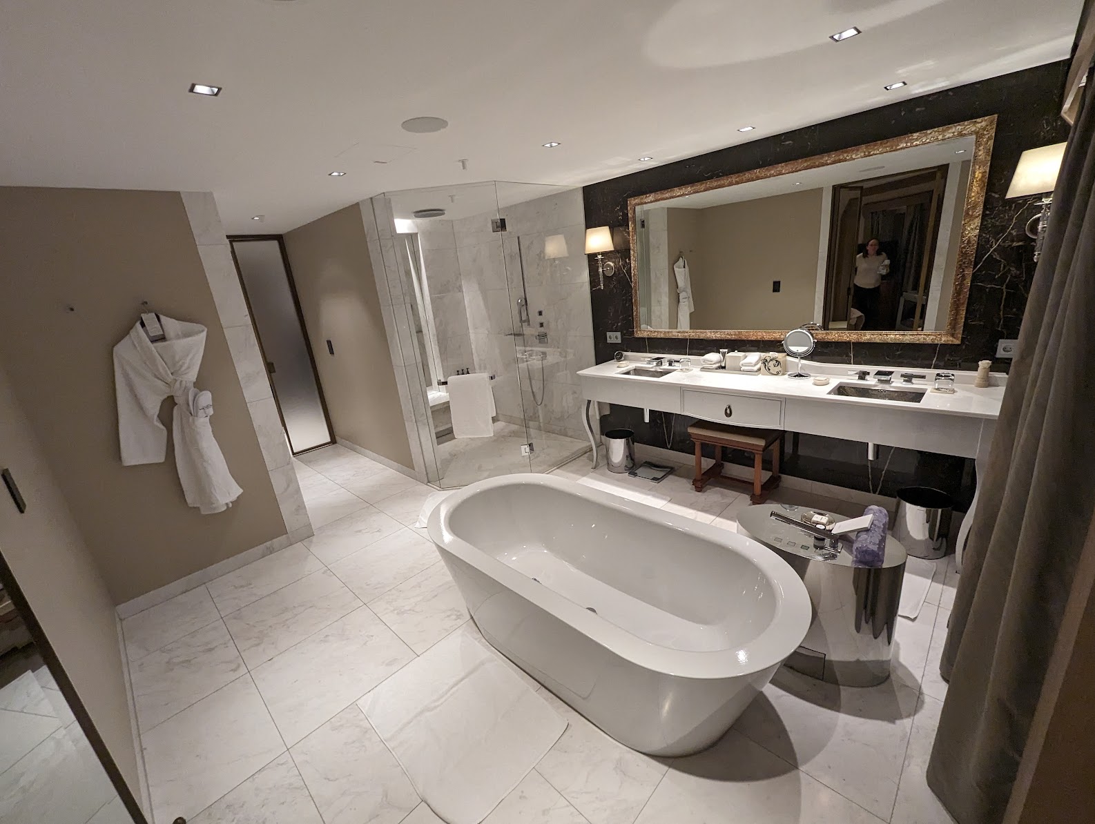 a bathroom with a large tub and a mirror