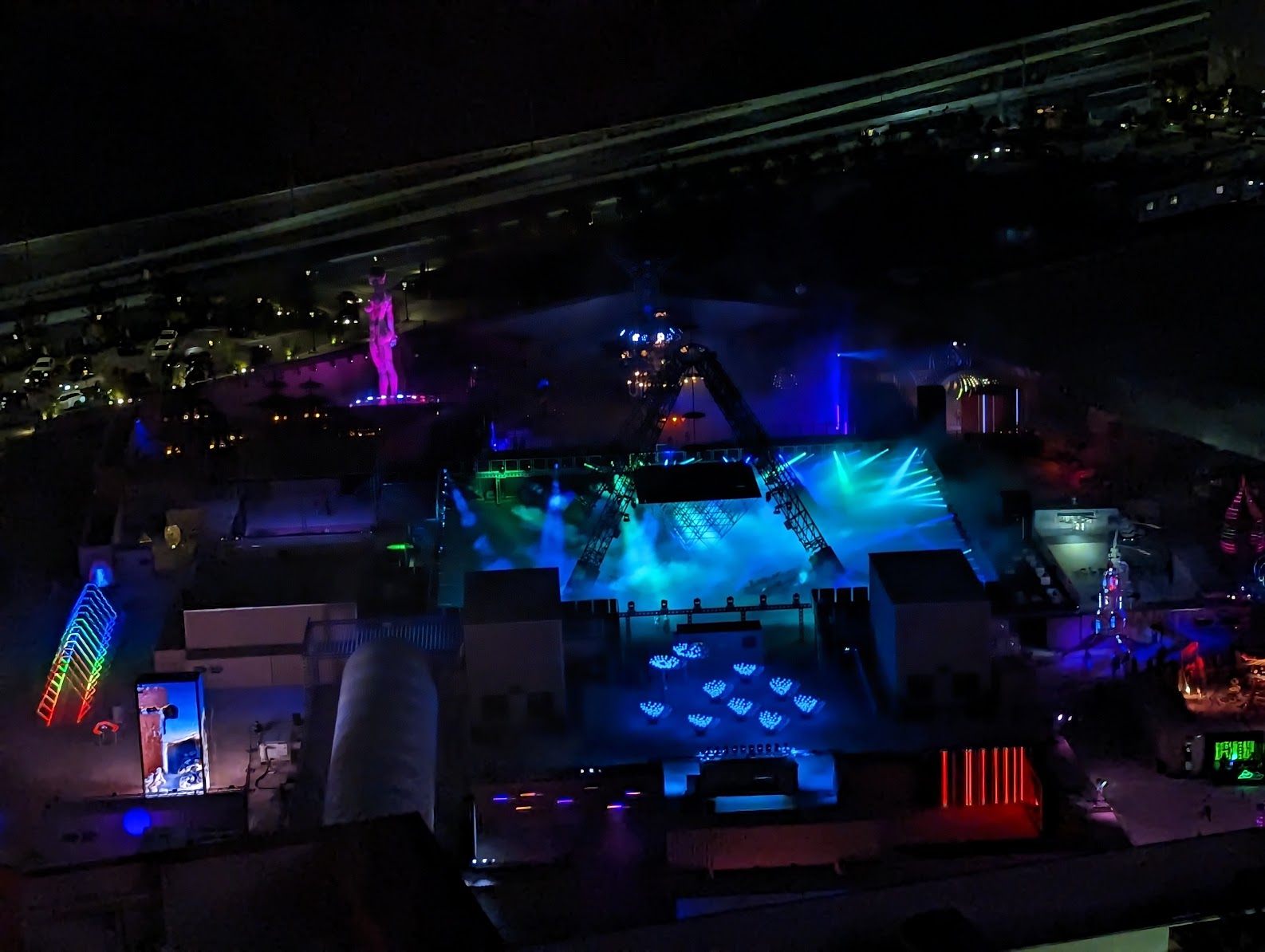 a aerial view of a stage with lights and a statue