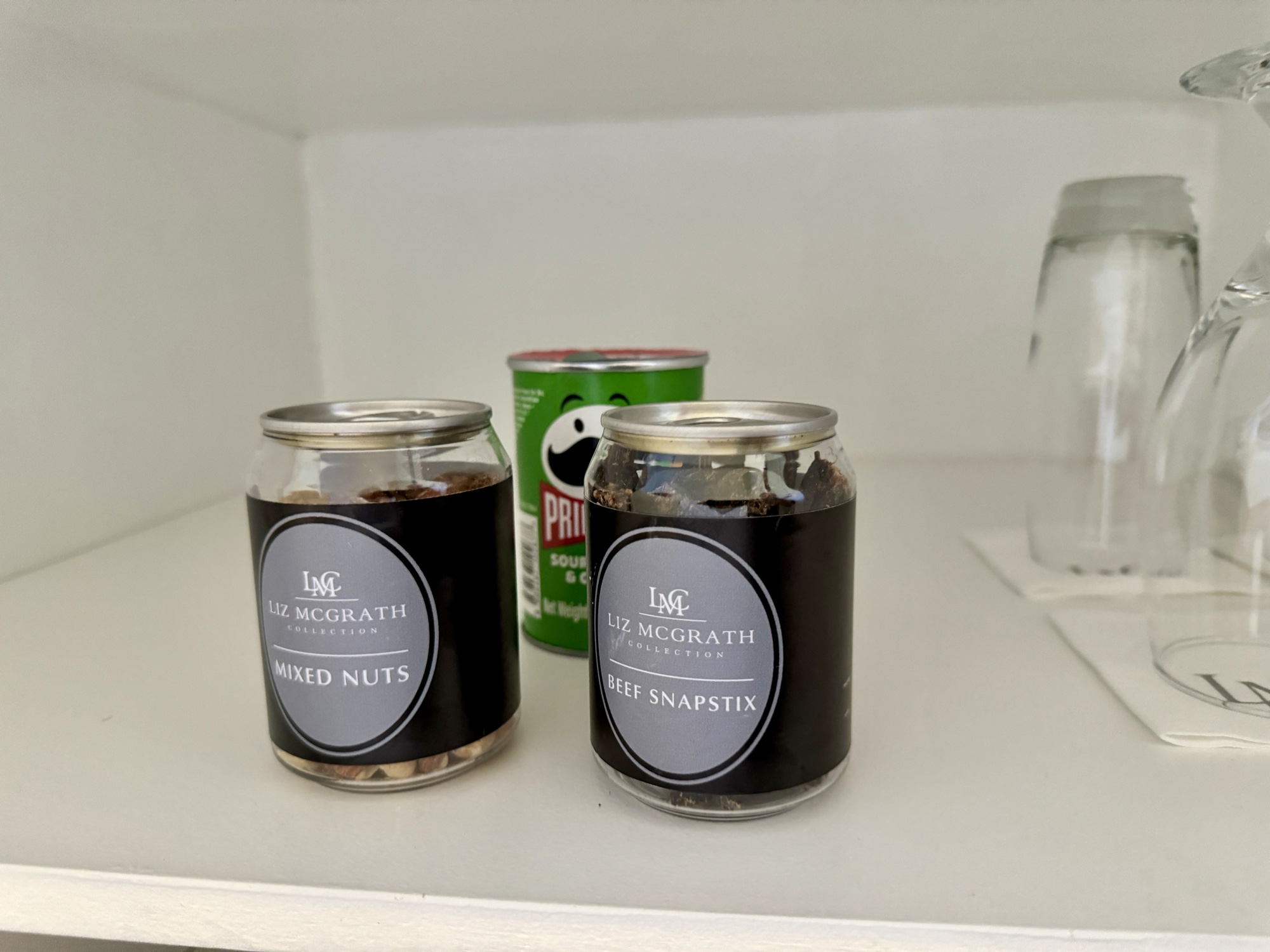 two jars of food on a white shelf