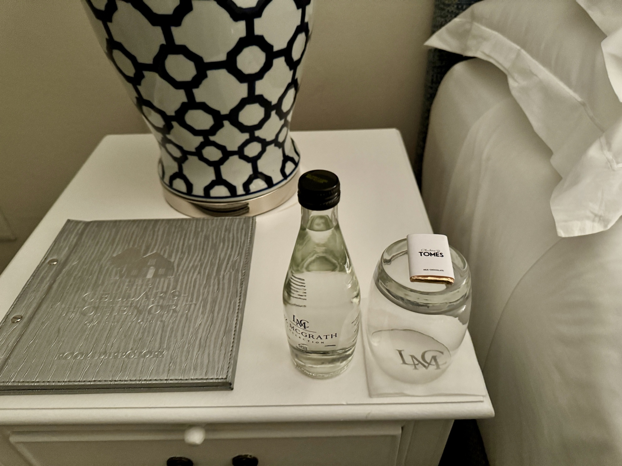 a table with a vase and a bottle of water on it