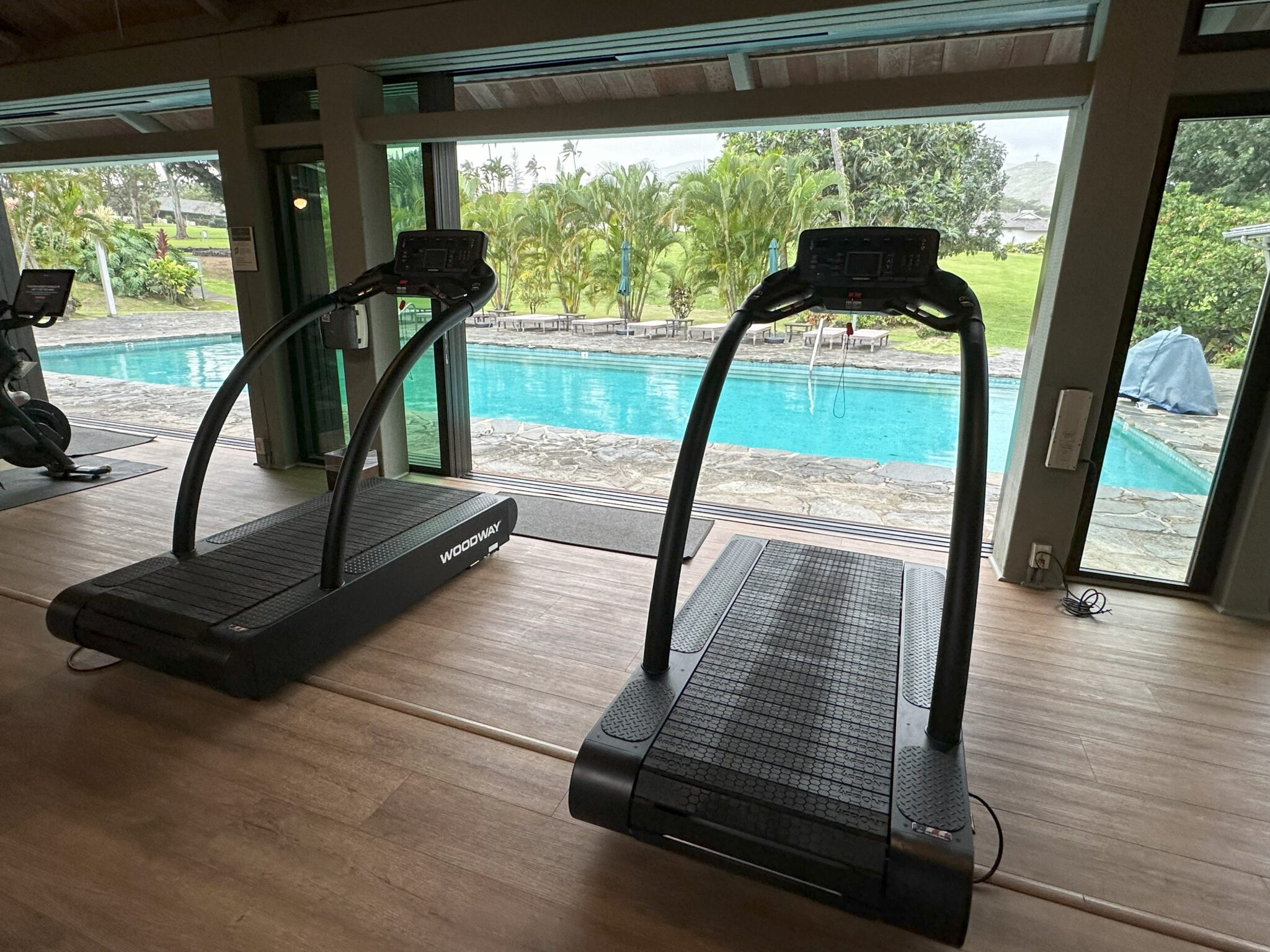 tread treadmills next to a pool