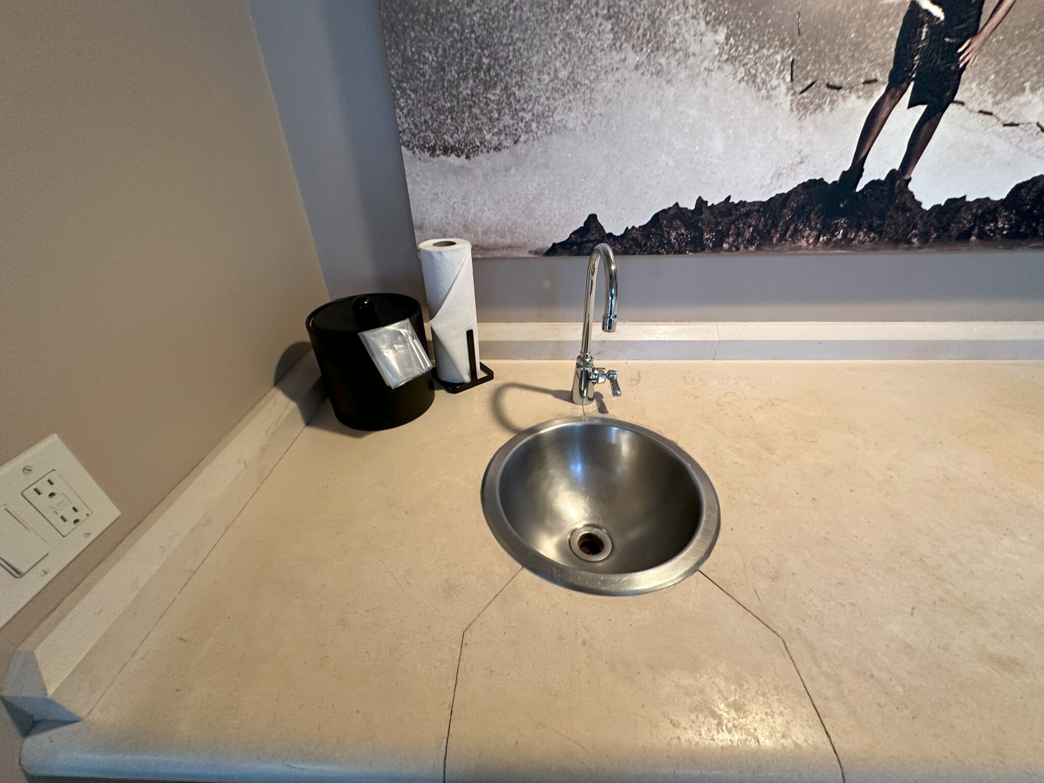 a sink and a poster on the wall