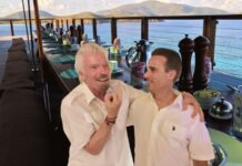 Picture shows Richard Branson giving the middle finger with his arm around Greg
