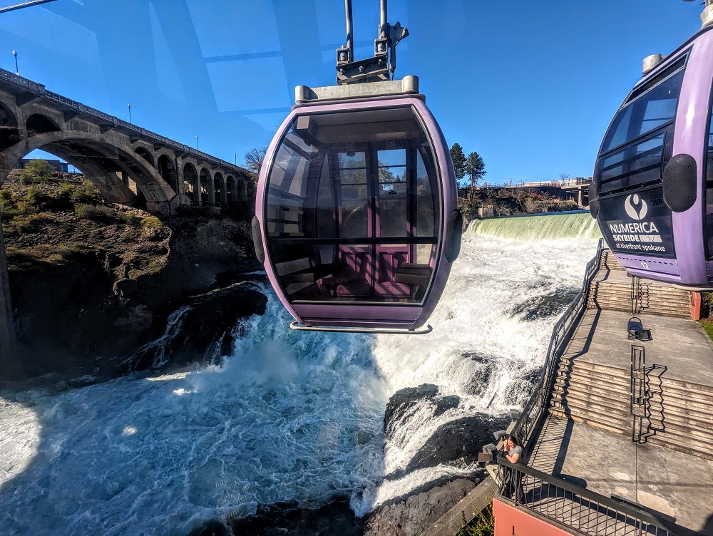 SkyRide cabin in front of Spokane Lower Falls