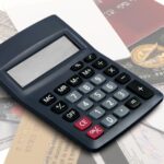 Pile of credit cards with calculator on top