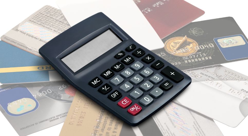 pile of credit cards with calculator on top