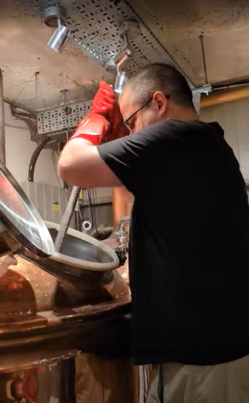Me mashing all the malted barley into the hot water