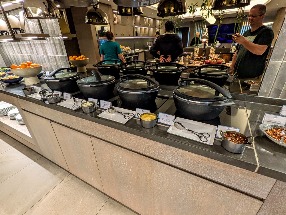 London Hilton on Park Lane - Executive lounge breakfast - Hot options included sausages, bacon, hash browns, eggs, and grilled tomatoes