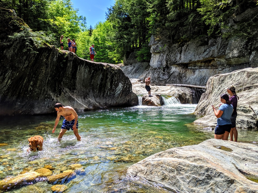 People cliff jumping at Warren Falls in Vermont